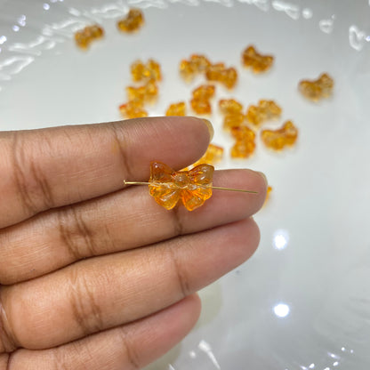 GB 909 orange bow glass bead- per piece