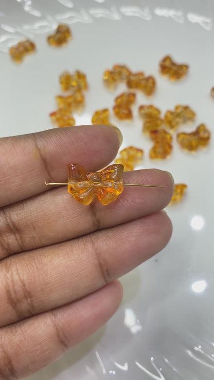 GB 909 orange bow glass bead- per piece